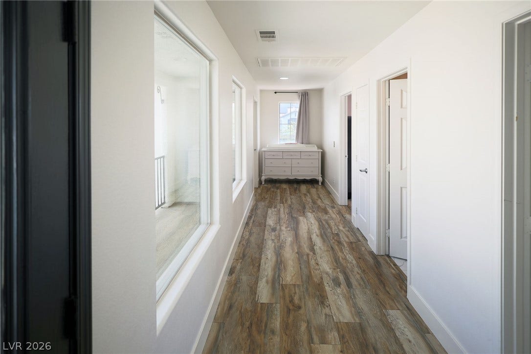 3018 Via Sarafina Drive, Henderson, NV 89052 Gleaming wood-look floors run throughout this bright upper-level corridor anchored by large interior windows.
