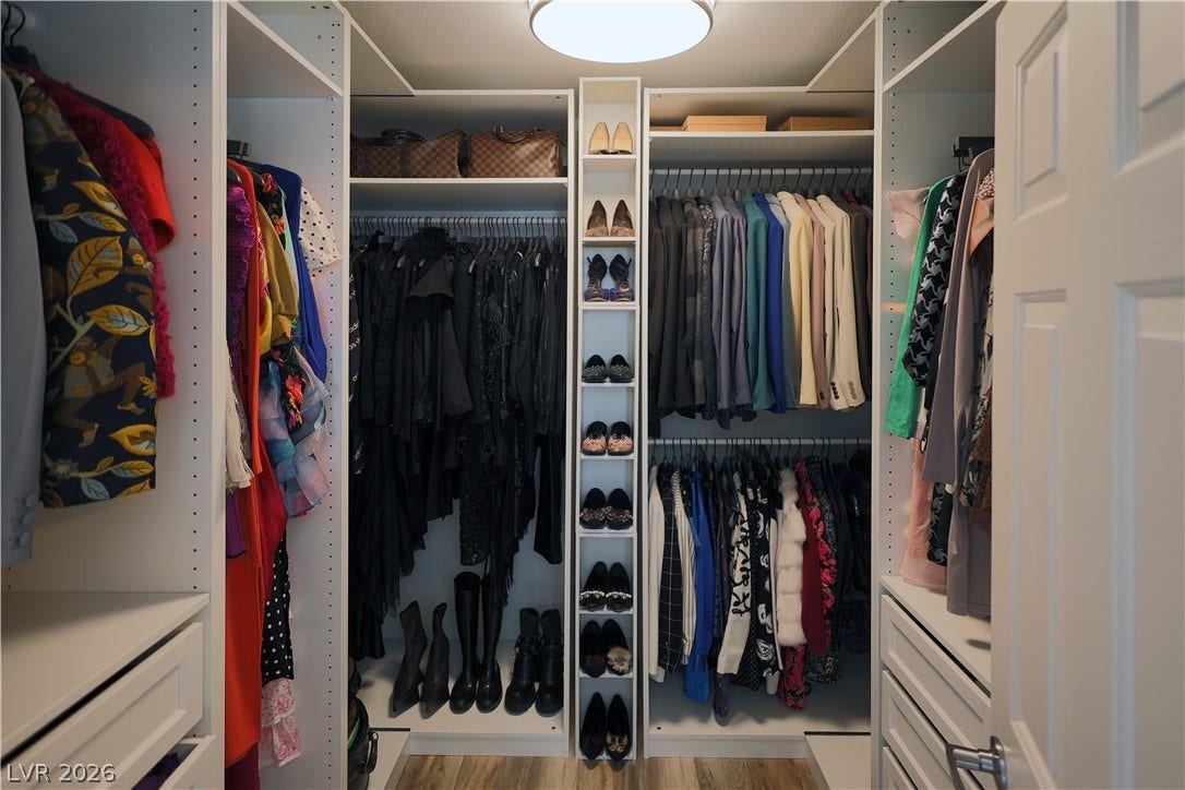 3018 Via Sarafina Drive, Henderson, NV 89052 Custom built-in shelving and ample hanging rods maximize organization in this functional walk-in closet.