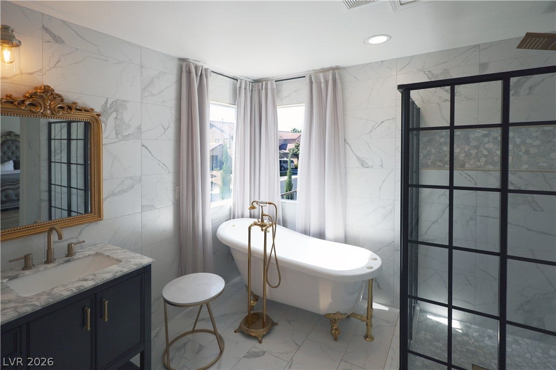 3018 Via Sarafina Drive, Henderson, NV 89052 Floor-to-ceiling tile surrounds a classic clawfoot tub and a modern glass shower.