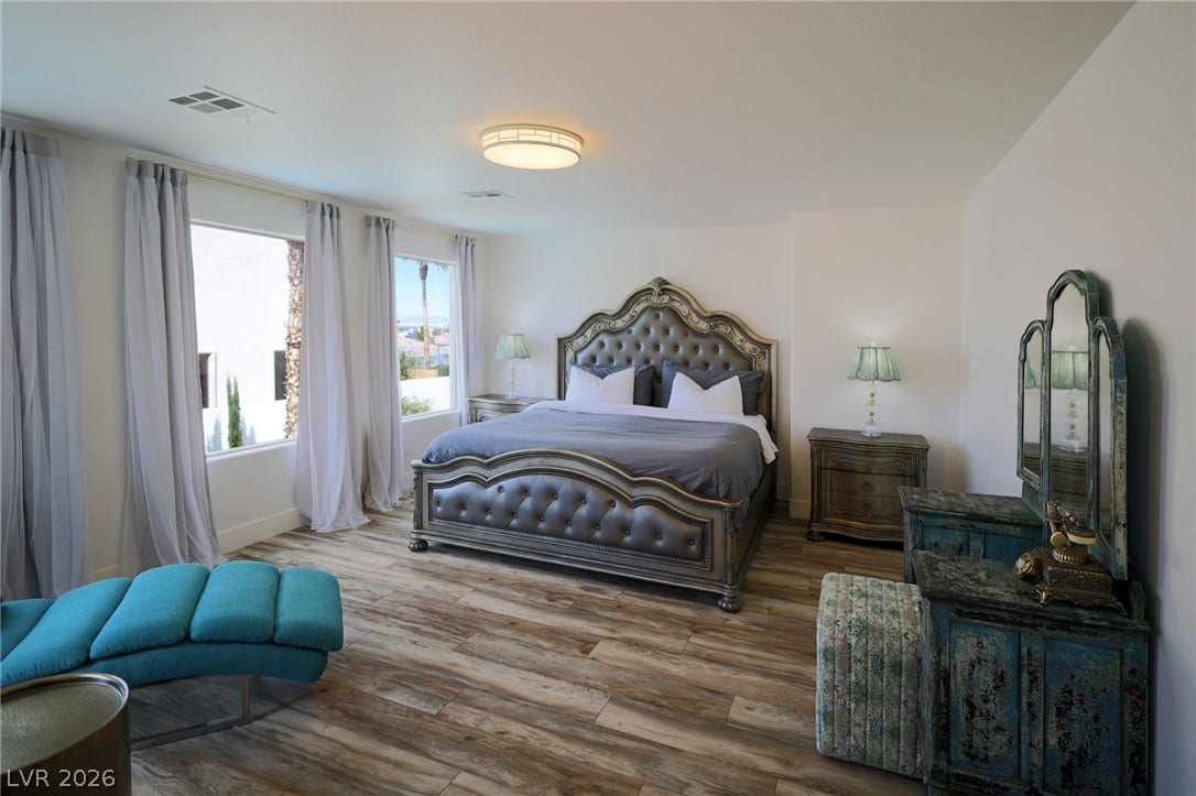 3018 Via Sarafina Drive, Henderson, NV 89052 Plank flooring and multiple windows enhance this comfortable main-level bedroom layout.