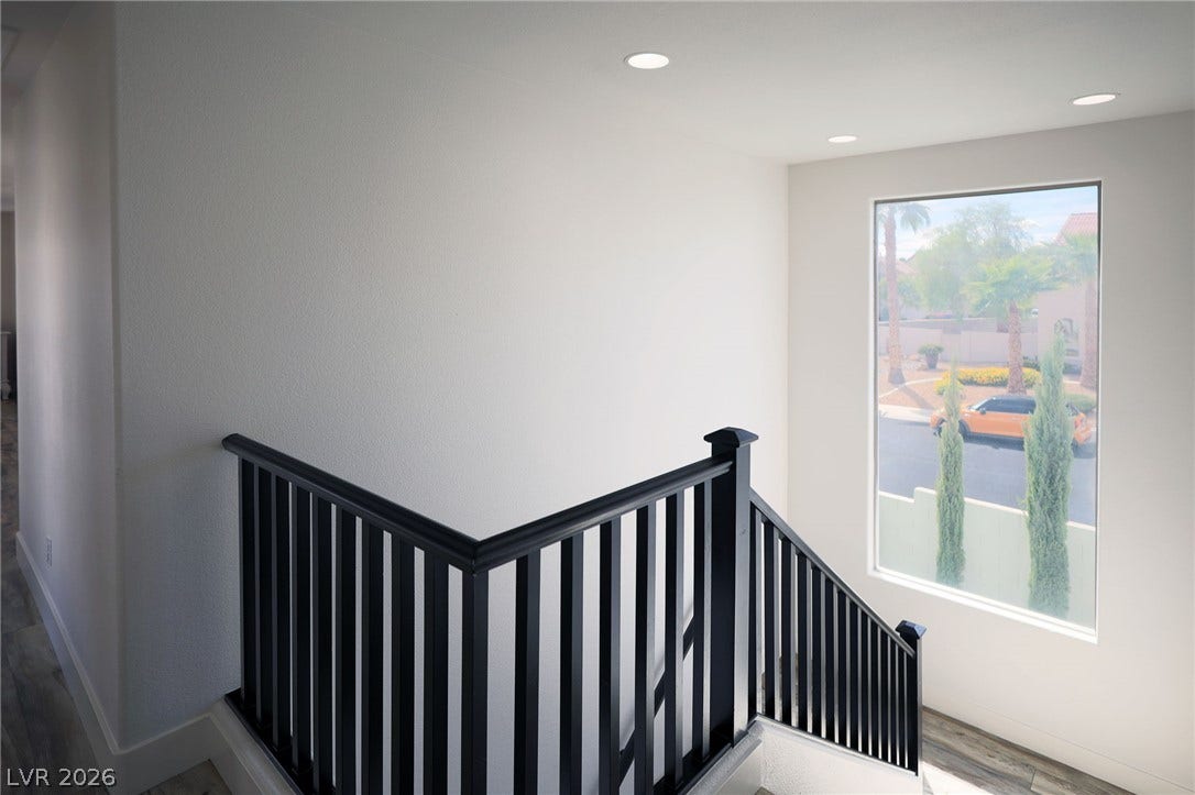 3018 Via Sarafina Drive, Henderson, NV 89052 A crisp modern staircase landing features a large picture window overlooking the neighborhood.