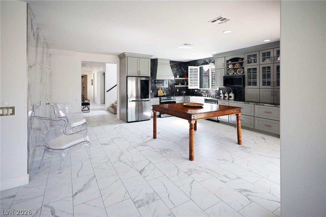 3018 Via Sarafina Drive, Henderson, NV 89052 Polished tile flooring and custom cabinetry define this expansive culinary space.