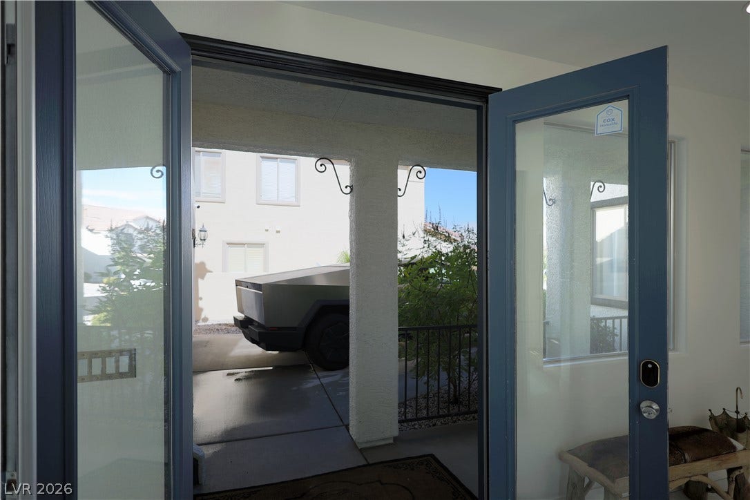 3018 Via Sarafina Drive, Henderson, NV 89052 Double glass doors open to reveal a covered driveway and entryway.