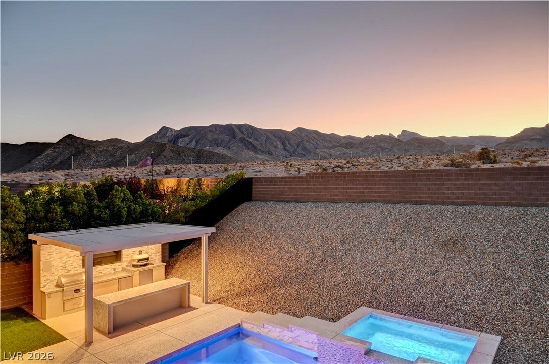 4709 Amazing View Street, Las Vegas, NV 89129 Dramatic mountain vistas frame the backyard oasis featuring a pool, spa, and covered outdoor kitchen.