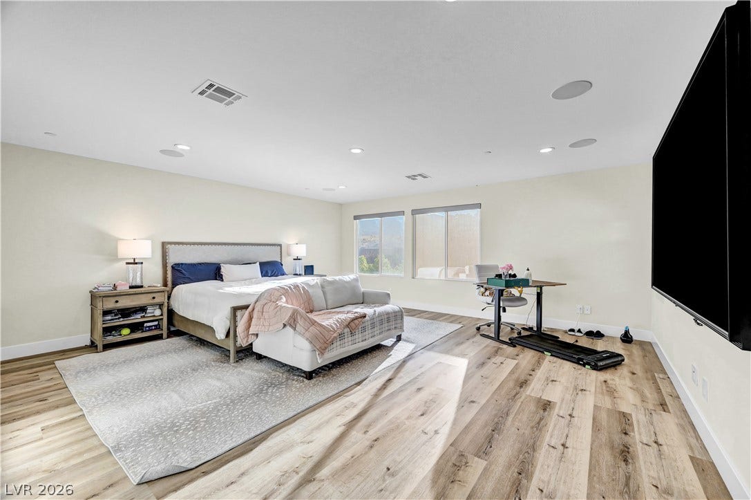 4709 Amazing View Street, Las Vegas, NV 89129 Smooth wood-plank flooring and recessed lighting define this spacious, window-lit main suite.