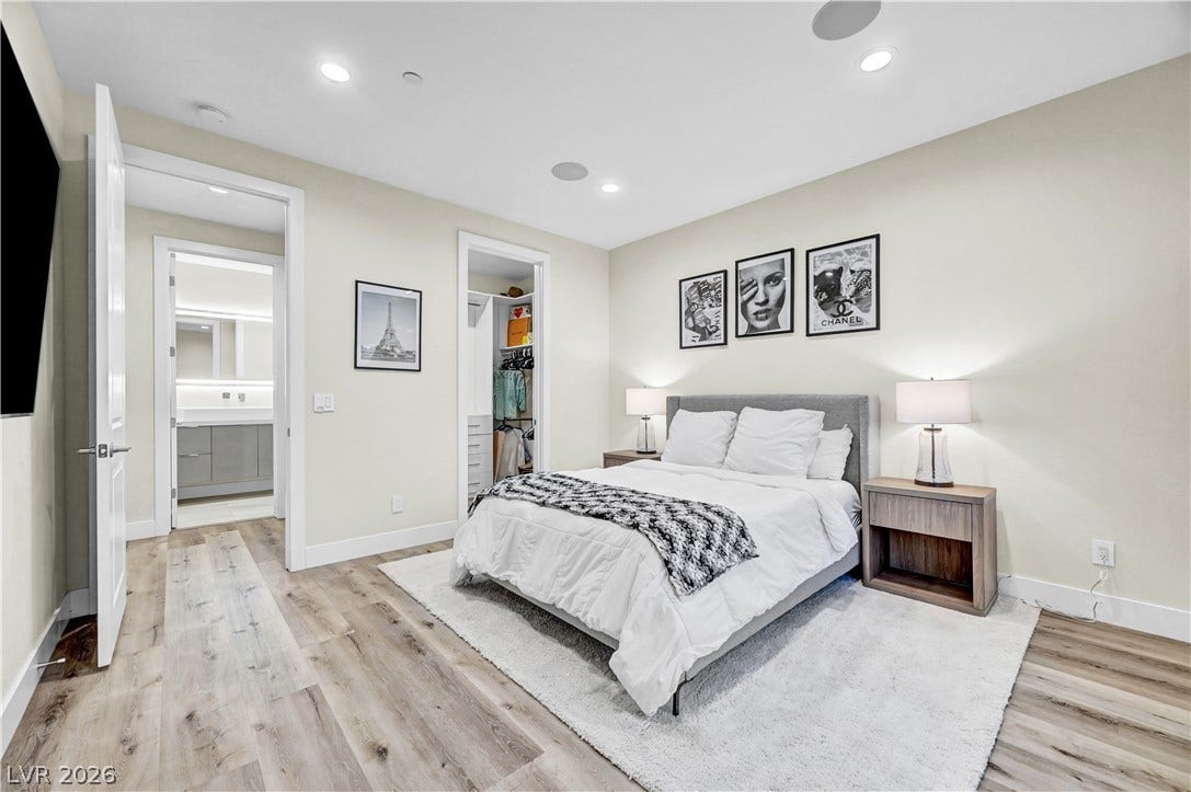 4709 Amazing View Street, Las Vegas, NV 89129 Smooth wood floors and recessed lighting anchor this peaceful bedroom with an attached bath.