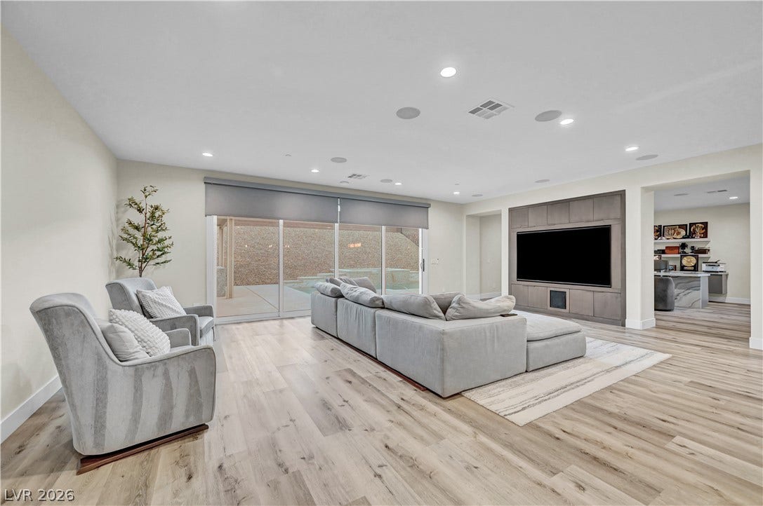 4709 Amazing View Street, Las Vegas, NV 89129 A spacious layout showcases light-toned hardwood flooring and a media center built directly into the wall.