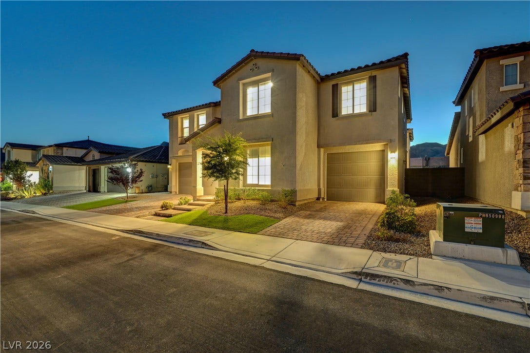 4709 Amazing View Street, Las Vegas, NV 89129 A paved driveway leads to a modern two-story exterior featuring neat desert landscaping.