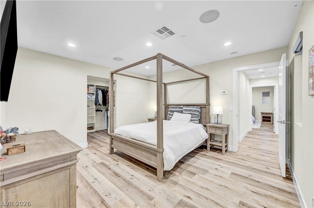 4709 Amazing View Street, Las Vegas, NV 89129 Gleaming wood-inspired flooring pairs beautifully with recessed lighting in this tranquil bedroom suite.