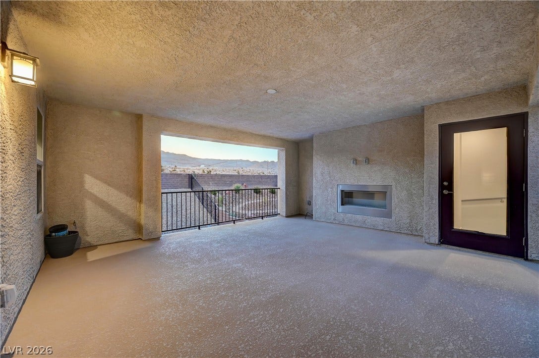 4709 Amazing View Street, Las Vegas, NV 89129 A spacious covered patio features a modern fireplace and mountain views.