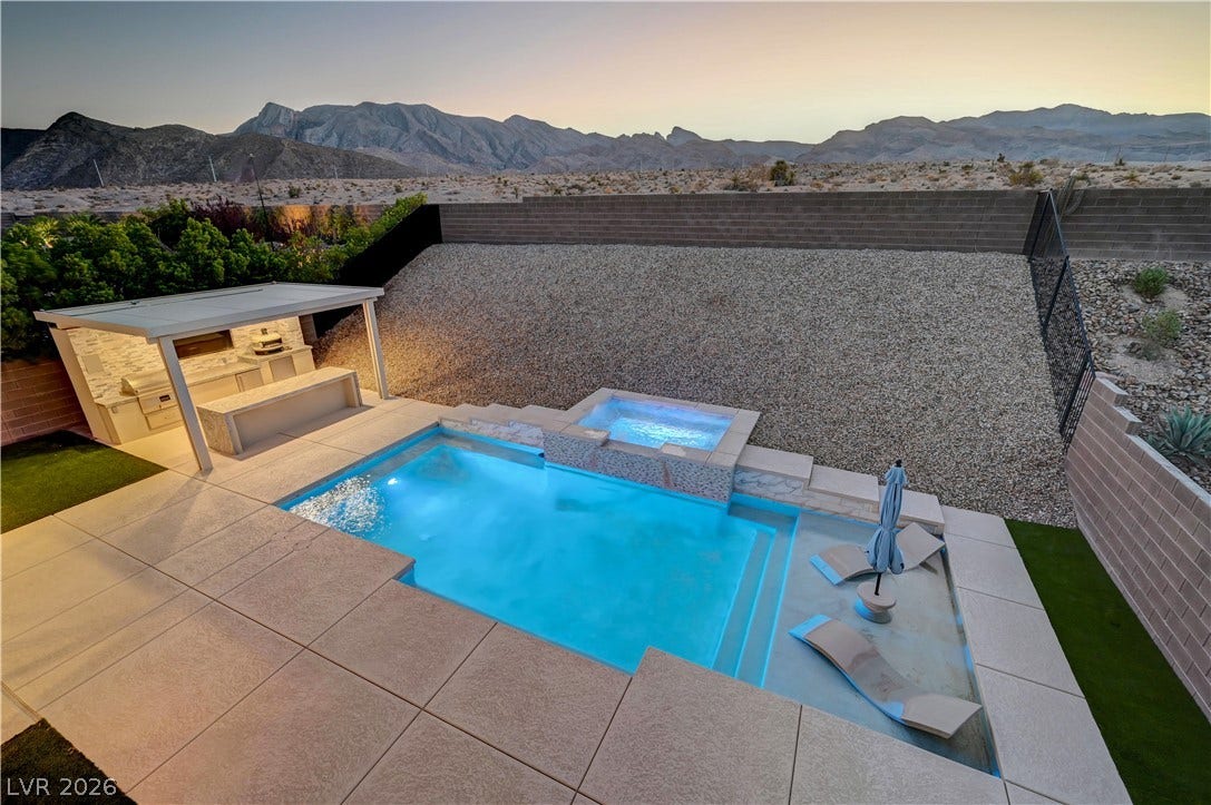 4709 Amazing View Street, Las Vegas, NV 89129 A sparkling geometric pool and elevated spa overlook a rugged mountain backdrop.