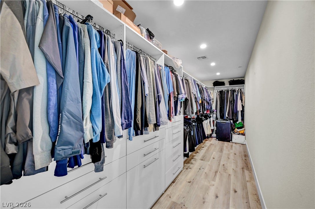 4709 Amazing View Street, Las Vegas, NV 89129 An expansive walk-in closet boasts custom built-in drawers and sleek wood-plank flooring.
