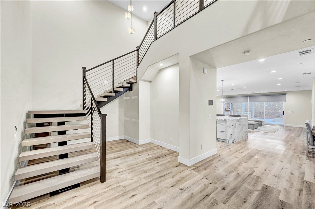 4709 Amazing View Street, Las Vegas, NV 89129 Clean lines and a modern floating staircase define this welcoming entry with hardwood flooring.