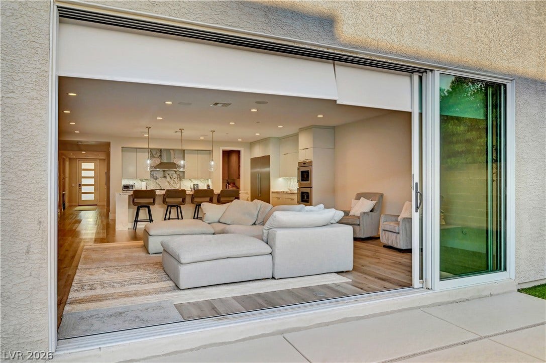 4709 Amazing View Street, Las Vegas, NV 89129 Massive sliding glass doors bridge the modern open-concept living area with the outdoor patio.