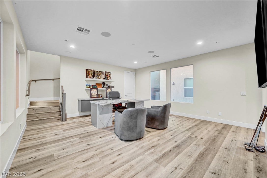 4709 Amazing View Street, Las Vegas, NV 89129 Gleaming wood-look floors and recessed lighting enhance this versatile workspace featuring wide windows.