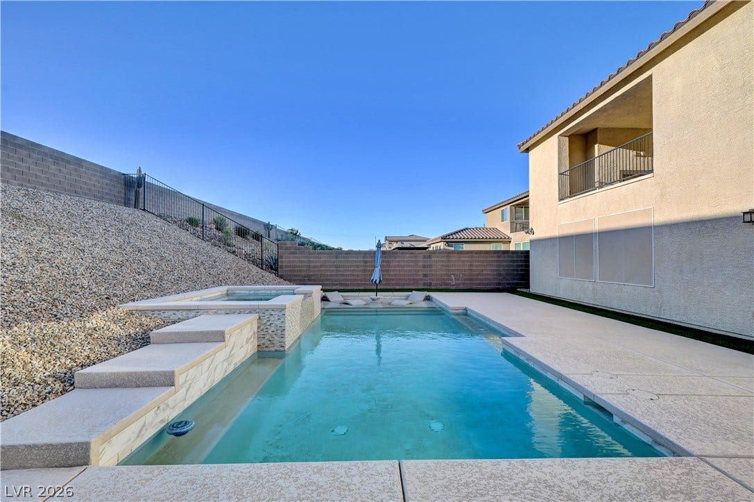 4709 Amazing View Street, Las Vegas, NV 89129 An inviting backyard oasis features a clean-lined swimming pool paired with an integrated spa.