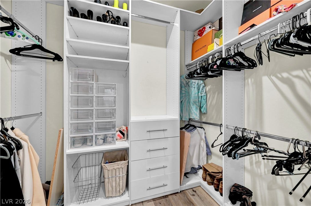 4709 Amazing View Street, Las Vegas, NV 89129 Custom built-in shelving and ample hanging rods maximize space in this walk-in closet.
