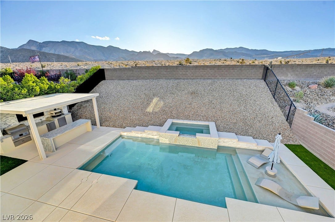 4709 Amazing View Street, Las Vegas, NV 89129 An inviting backyard oasis offers a pristine swimming pool against a backdrop of majestic mountain vistas.