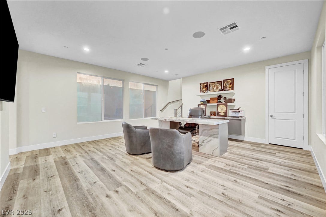 4709 Amazing View Street, Las Vegas, NV 89129 Recessed lighting and wood-look flooring establish a clean, contemporary feel in this versatile room.