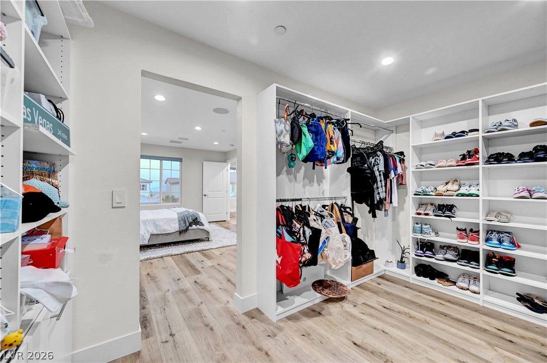 4709 Amazing View Street, Las Vegas, NV 89129 Ample custom shelving and wood flooring define this generously sized walk-in closet space.