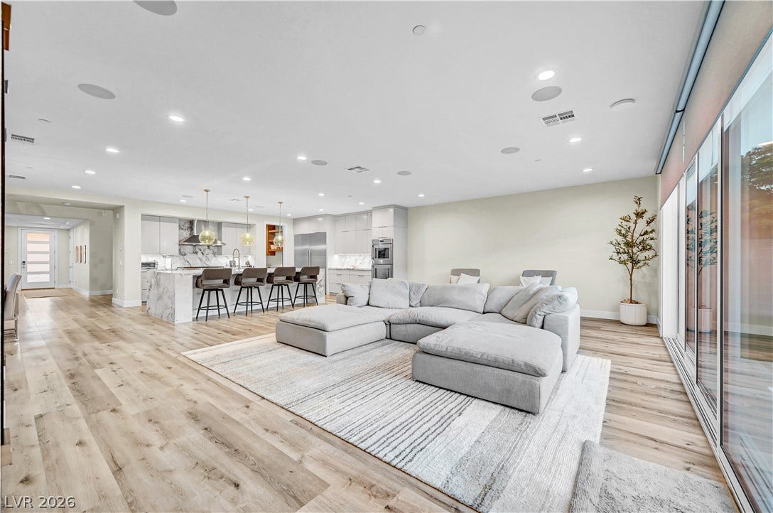4709 Amazing View Street, Las Vegas, NV 89129 Gleaming wood floors and recessed lighting anchor this open-concept layout leading into the kitchen.