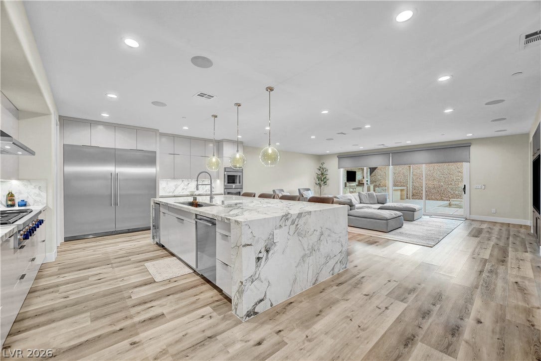 4709 Amazing View Street, Las Vegas, NV 89129 An open floorplan seamlessly connects the stone-island kitchen to the adjacent living area.