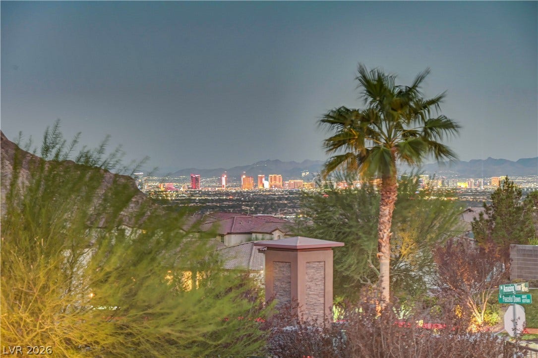 4709 Amazing View Street, Las Vegas, NV 89129 Distant city lights shimmer below a backdrop of majestic desert mountains.
