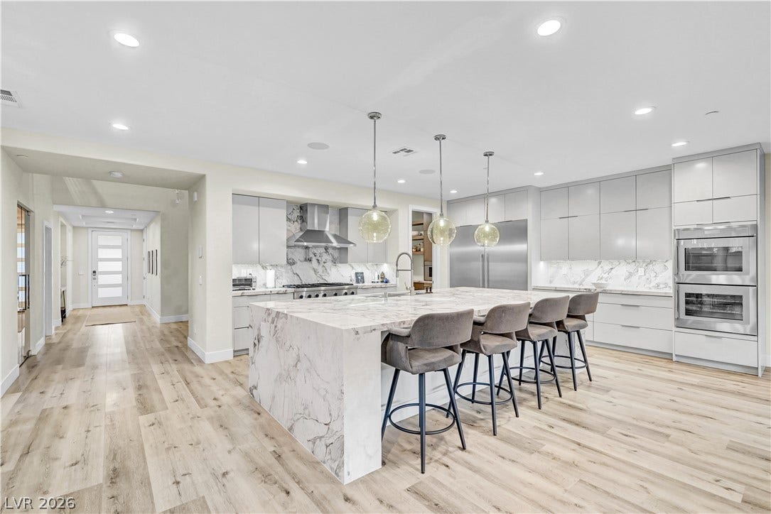 4709 Amazing View Street, Las Vegas, NV 89129 Rich marble surfaces and warm hardwood floors anchor this open culinary space.