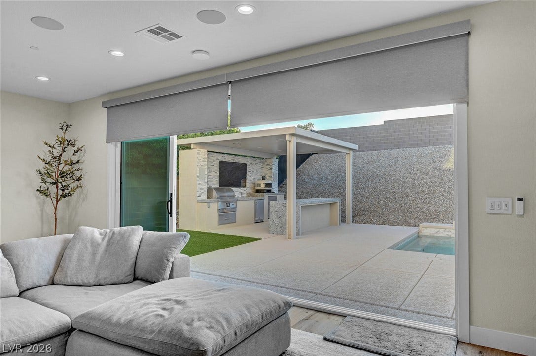 4709 Amazing View Street, Las Vegas, NV 89129 Large sliding glass doors open directly to a covered outdoor kitchen and private pool area.