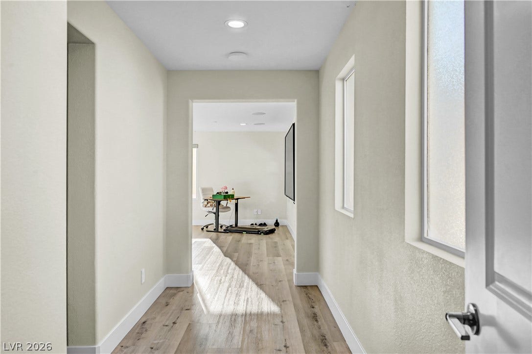 4709 Amazing View Street, Las Vegas, NV 89129 Recessed lighting and warm wood flooring guide the way through this inviting hallway passage.