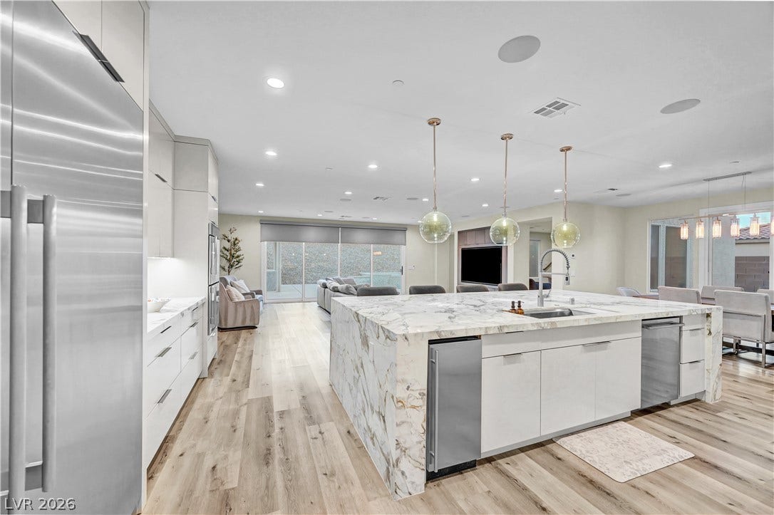 4709 Amazing View Street, Las Vegas, NV 89129 Gleaming stone countertops and warm wood floors define this open culinary space.