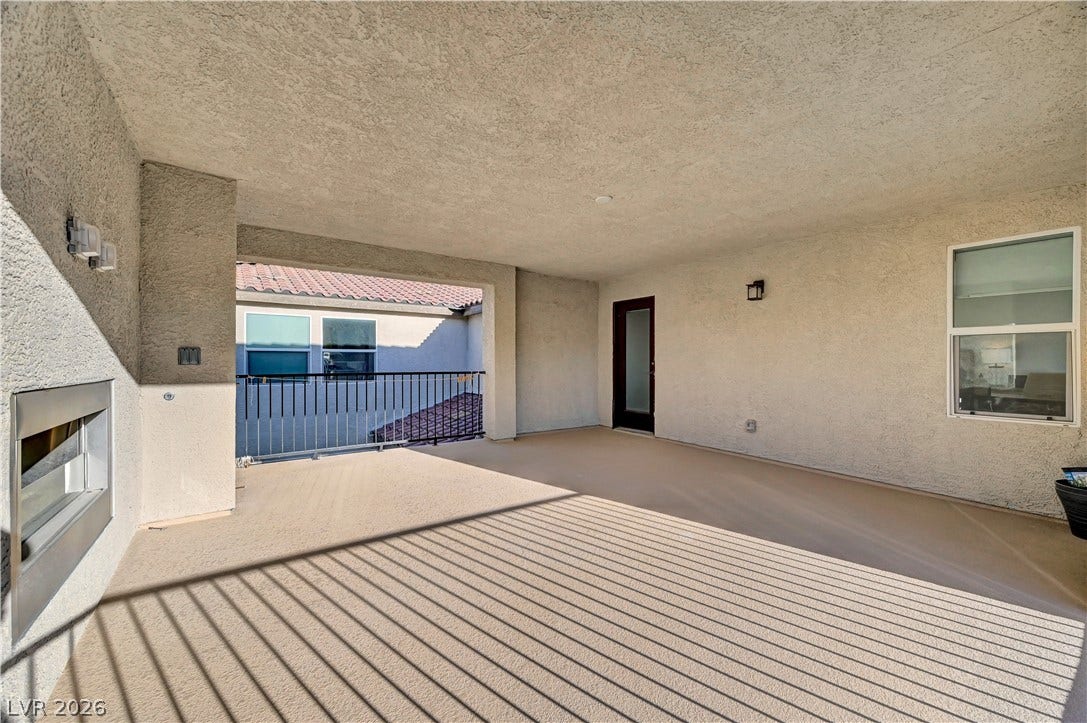 4709 Amazing View Street, Las Vegas, NV 89129 A spacious covered balcony provides an ideal outdoor retreat with a cozy built-in fireplace.