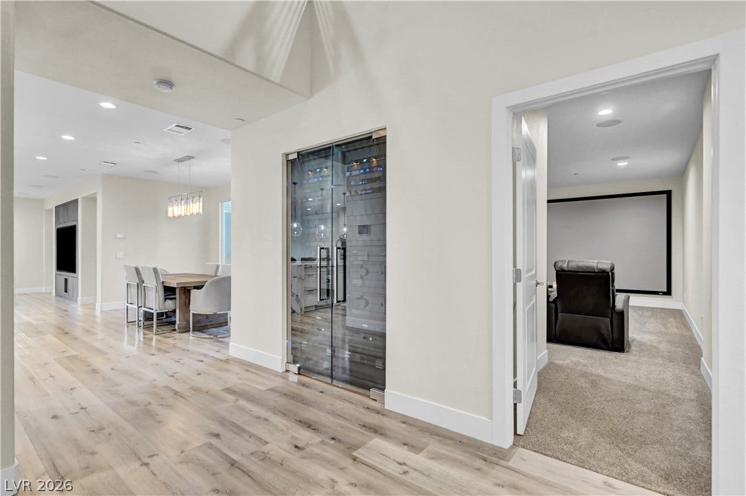 4709 Amazing View Street, Las Vegas, NV 89129 Modern wide-plank flooring connects the main living spaces with a dedicated home theater room.