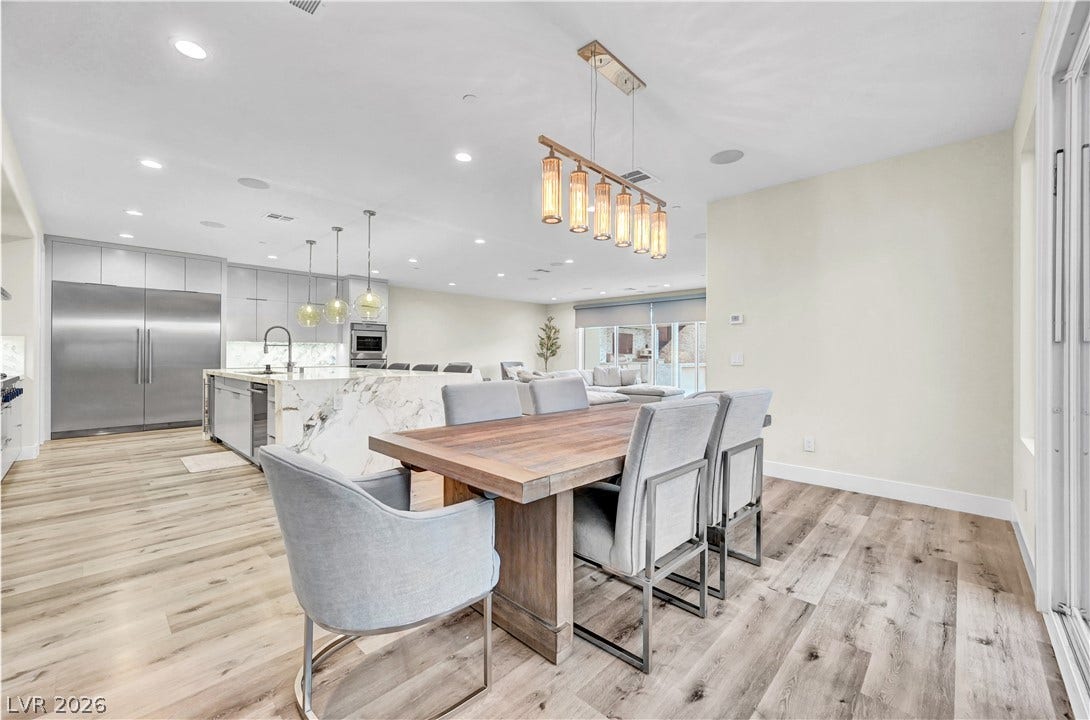 4709 Amazing View Street, Las Vegas, NV 89129 Warm wood flooring and recessed lighting connect the open-concept dining area to the kitchen.