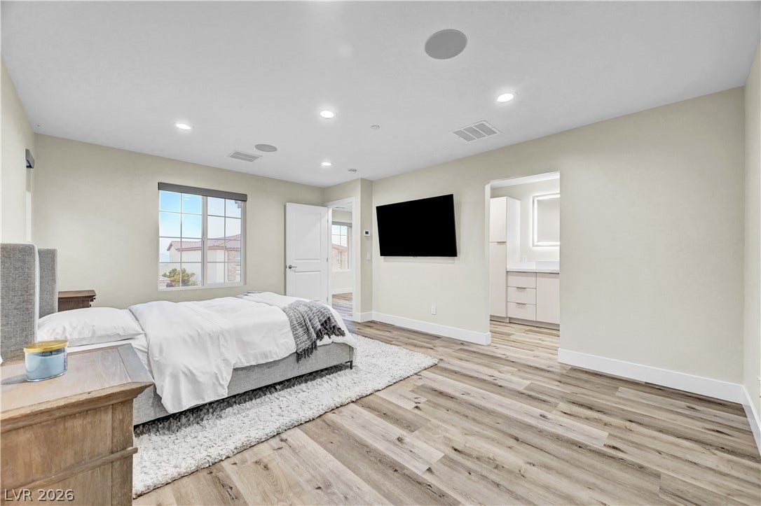 4709 Amazing View Street, Las Vegas, NV 89129 Recessed lighting illuminates this bedroom finished with wood flooring.