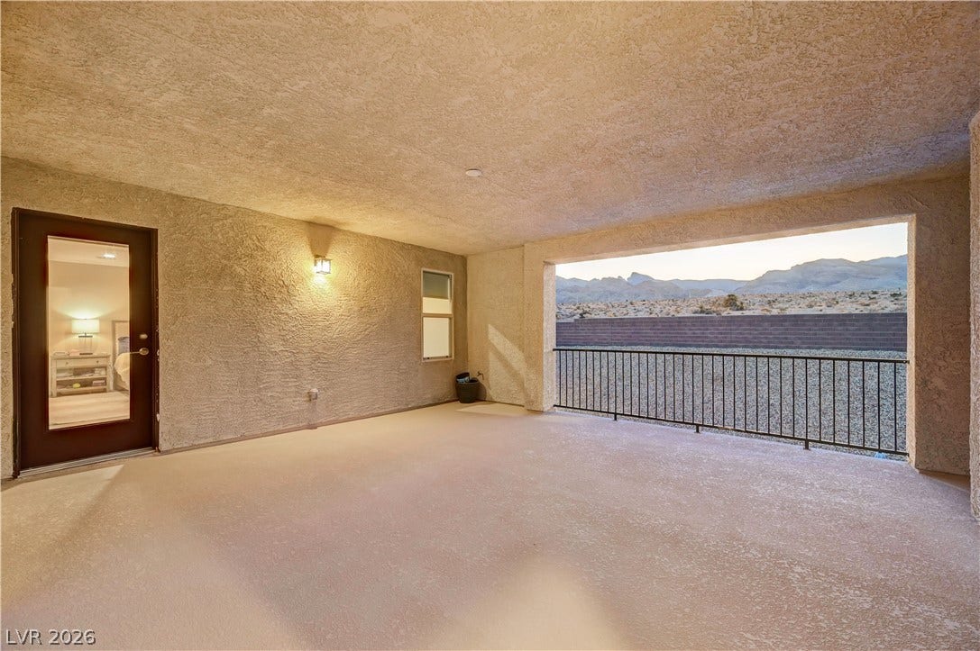 4709 Amazing View Street, Las Vegas, NV 89129 A spacious covered terrace frames sweeping desert and mountain vistas through a wide opening.