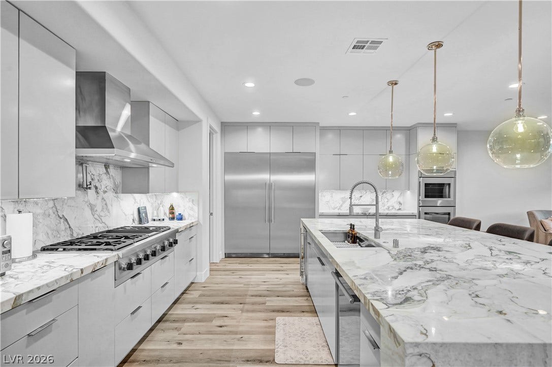 4709 Amazing View Street, Las Vegas, NV 89129 Gleaming marble counters and premium integrated appliances define this modern chef's kitchen.