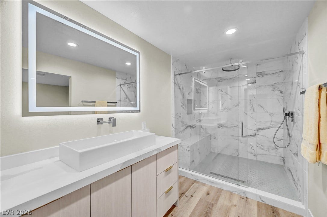 4709 Amazing View Street, Las Vegas, NV 89129 Clean lines and a spacious walk-in shower define this modern, light-filled washroom.