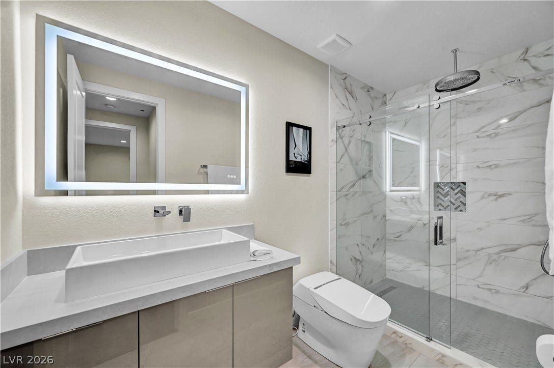 4709 Amazing View Street, Las Vegas, NV 89129 A glass-enclosed shower highlights this modern bathroom with a contemporary vessel sink.