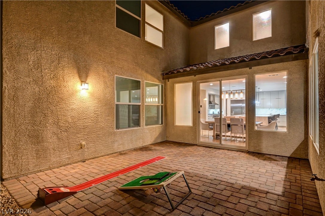 4709 Amazing View Street, Las Vegas, NV 89129 An inviting paved courtyard offers seamless entry into the home through wide sliding glass doors.