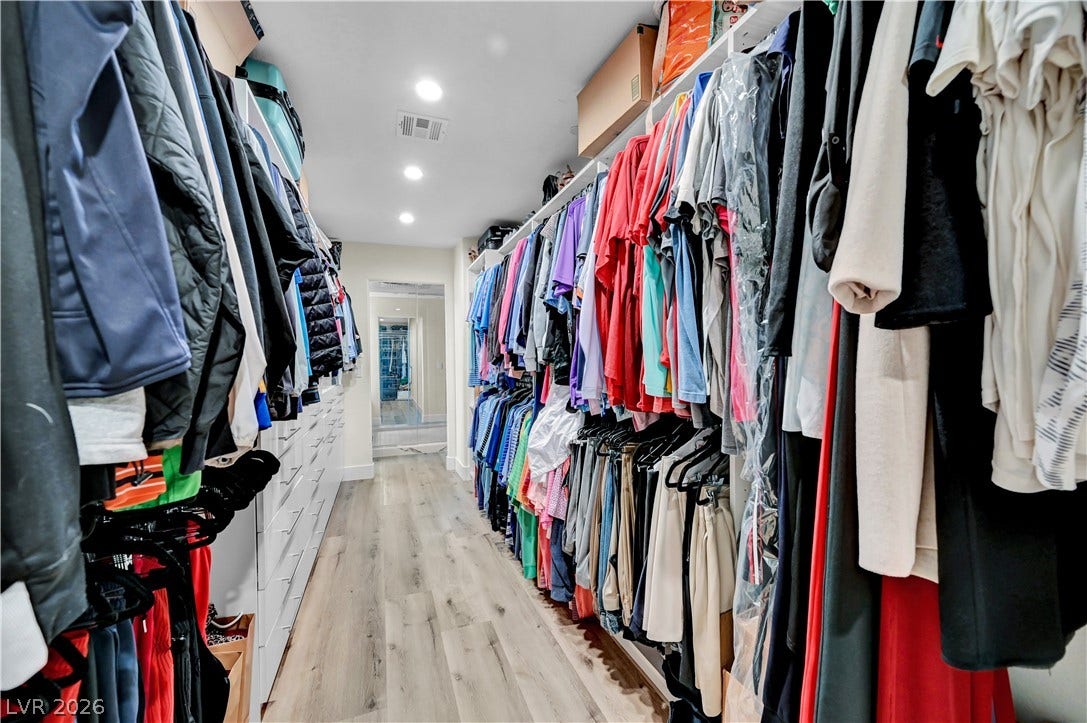 4709 Amazing View Street, Las Vegas, NV 89129 An abundance of storage space highlights this long walk-in closet with recessed lighting and wood floors.