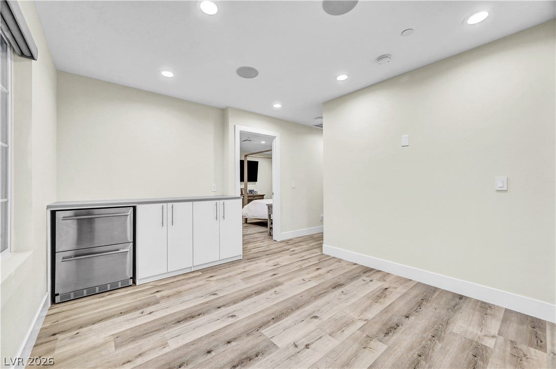 4709 Amazing View Street, Las Vegas, NV 89129 Smooth wood-plank flooring and built-in cabinetry define this versatile transitional space.