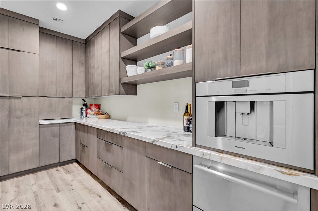4709 Amazing View Street, Las Vegas, NV 89129 Gleaming stone countertops and custom flat-panel cabinetry elevate this modern butler pantry.