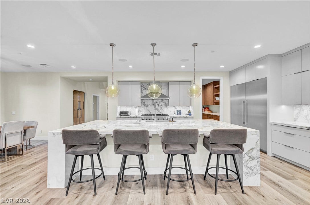 4709 Amazing View Street, Las Vegas, NV 89129 Gleaming stone countertops and modern cabinetry highlight this open-concept culinary space.