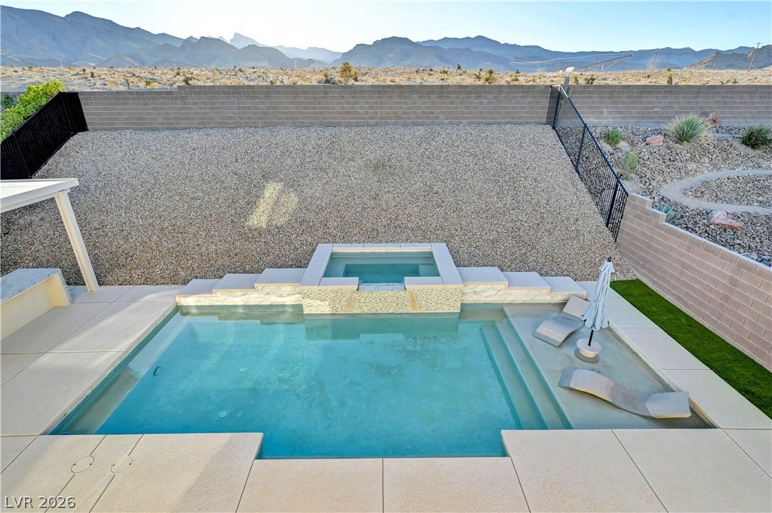 4709 Amazing View Street, Las Vegas, NV 89129 An inviting backyard swimming pool and integrated spa frame dramatic desert mountain views.