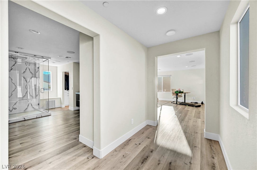 4709 Amazing View Street, Las Vegas, NV 89129 Modern wood-look flooring and crisp recessed lighting run throughout this bright, open hallway area.