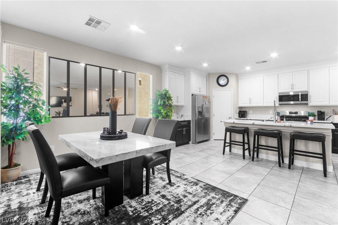 7224 Halo Falls Street, North Las Vegas, NV 89084 A streamlined kitchen and dining area feature sleek cabinetry and a convenient island with seating.