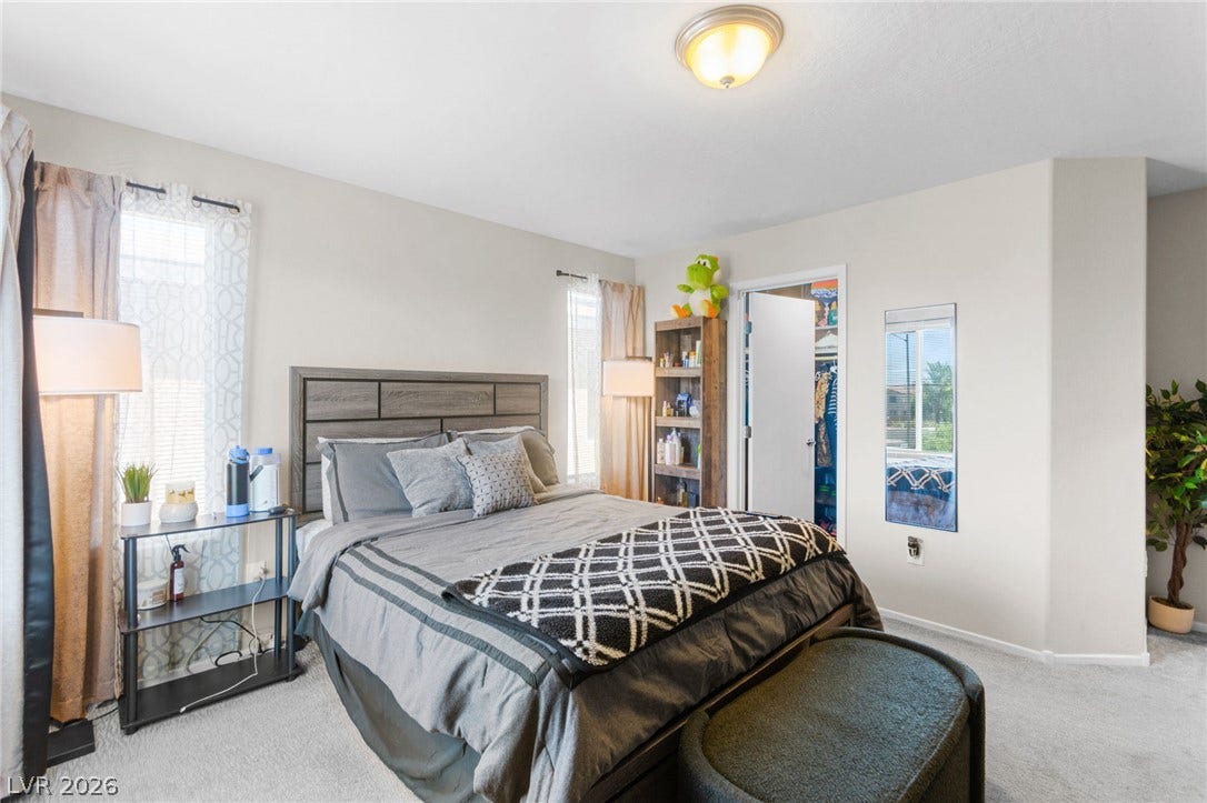 7224 Halo Falls Street, North Las Vegas, NV 89084 A comfortable bedroom features carpet flooring and a generously sized closet for ample storage.