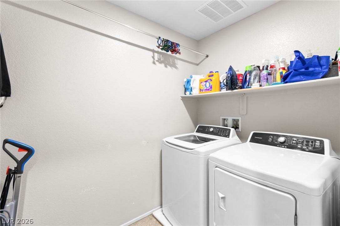 7224 Halo Falls Street, North Las Vegas, NV 89084 Functional laundry space featuring modern appliances and a convenient storage shelf.
