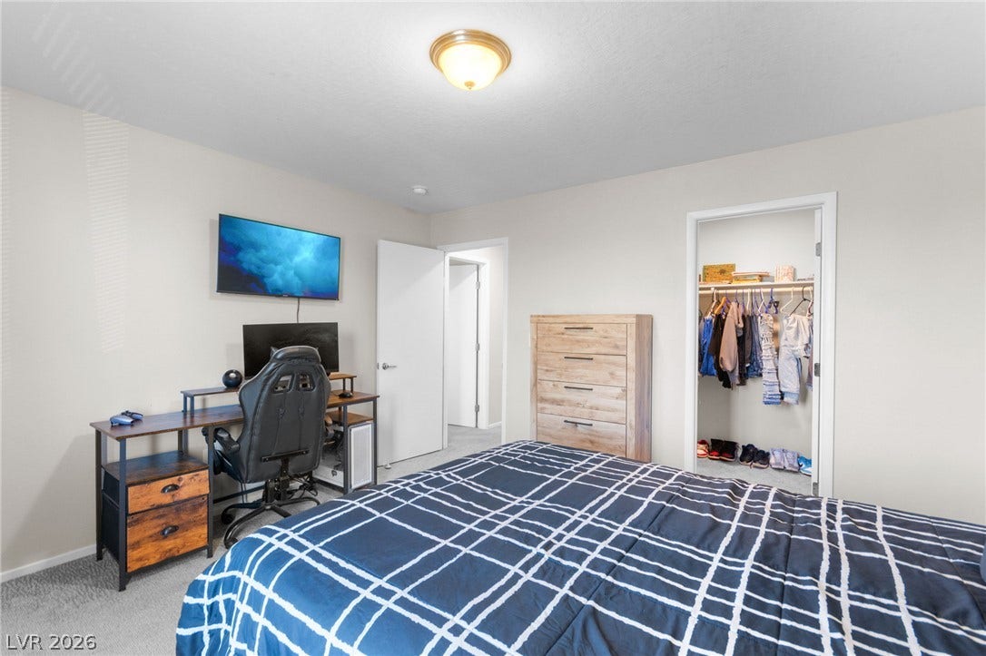 7224 Halo Falls Street, North Las Vegas, NV 89084 A well-lit bedroom provides comfortable living with a dedicated workspace and convenient closet access.